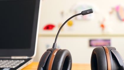 headset with mic next to a laptop 